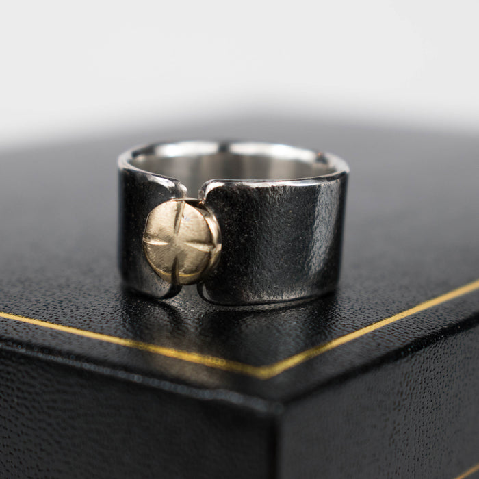 Black and gold button ring