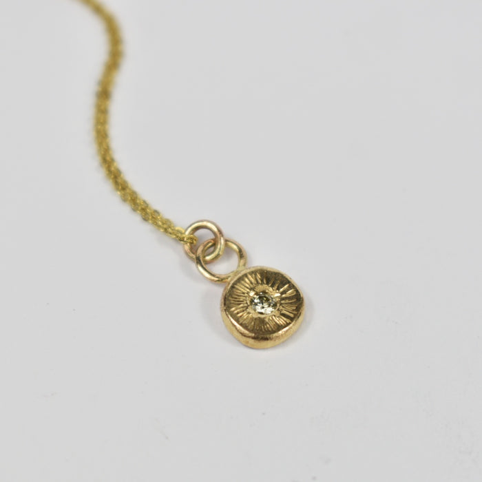 Diamond and gold circle pendant
