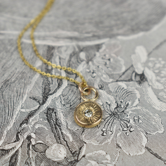 Diamond and gold circle pendant